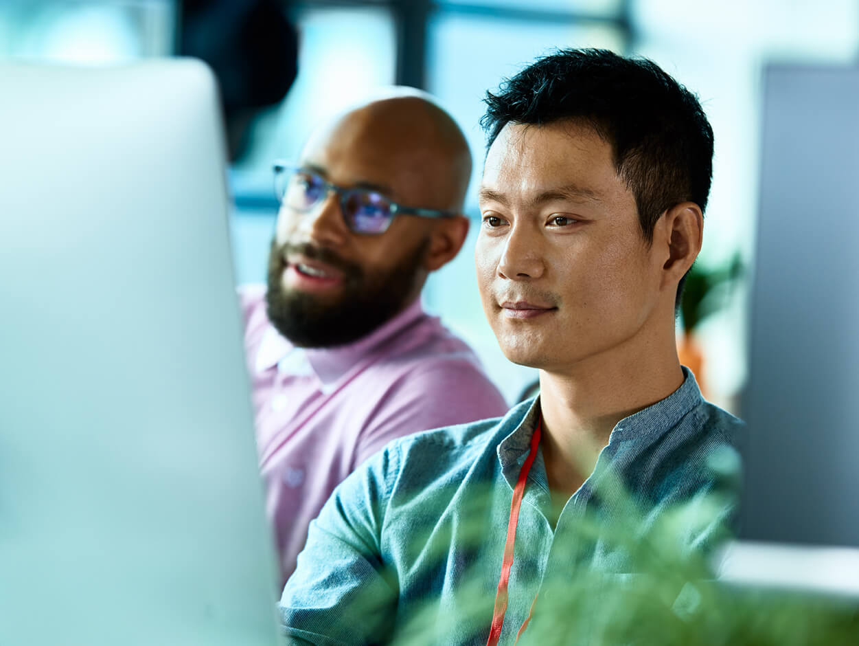 AML 2 men looking at desktop screen